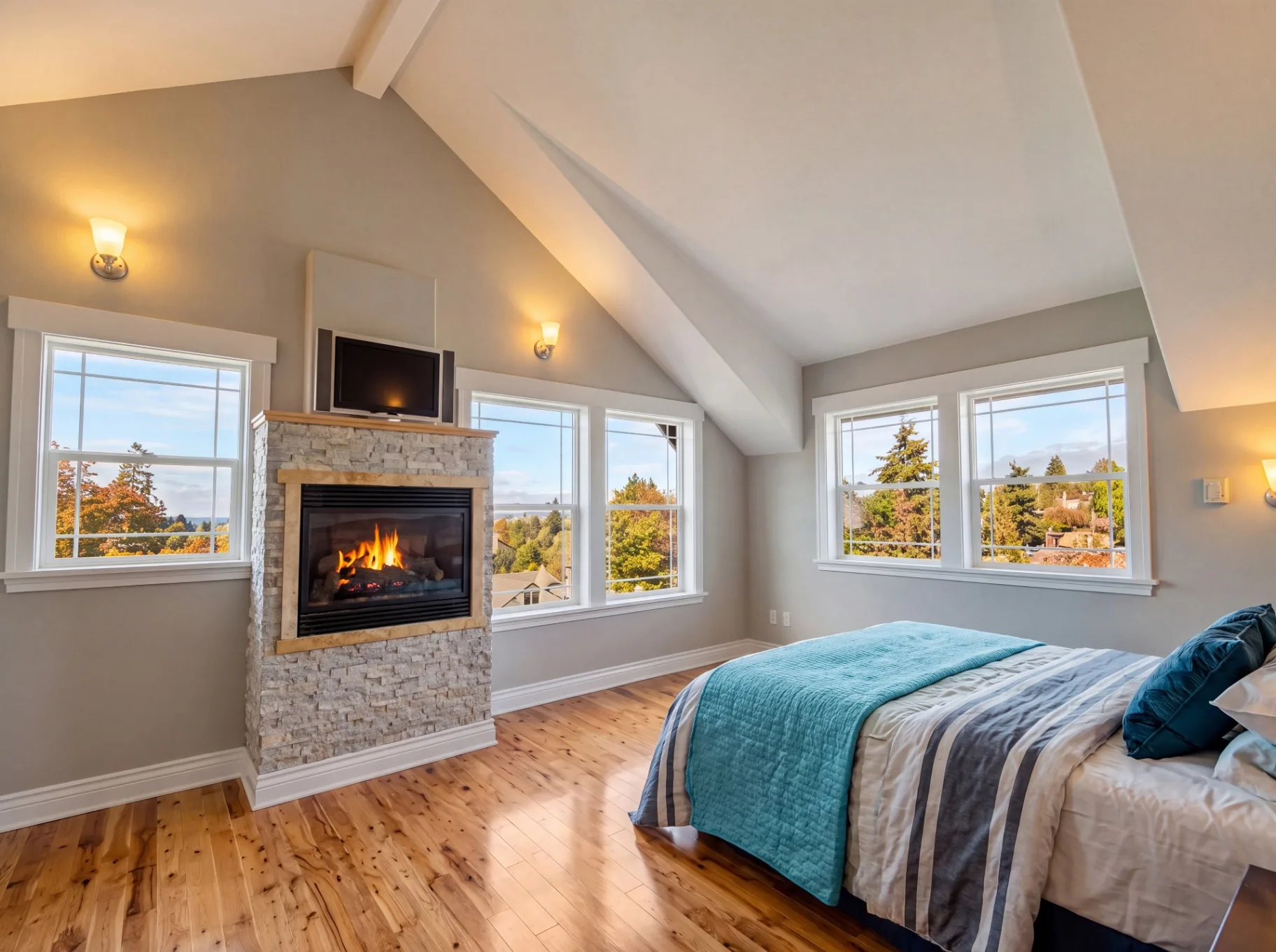 Master bedroom addition with stone fireplace by Primier Building & Construction